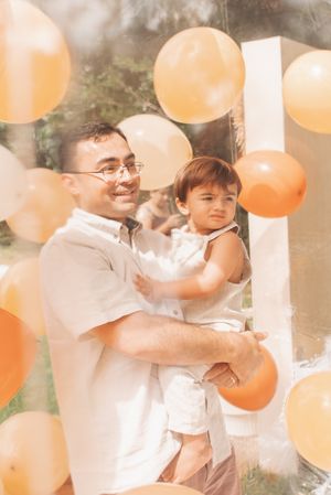 Warm-toned party scene with orange and white balloons.