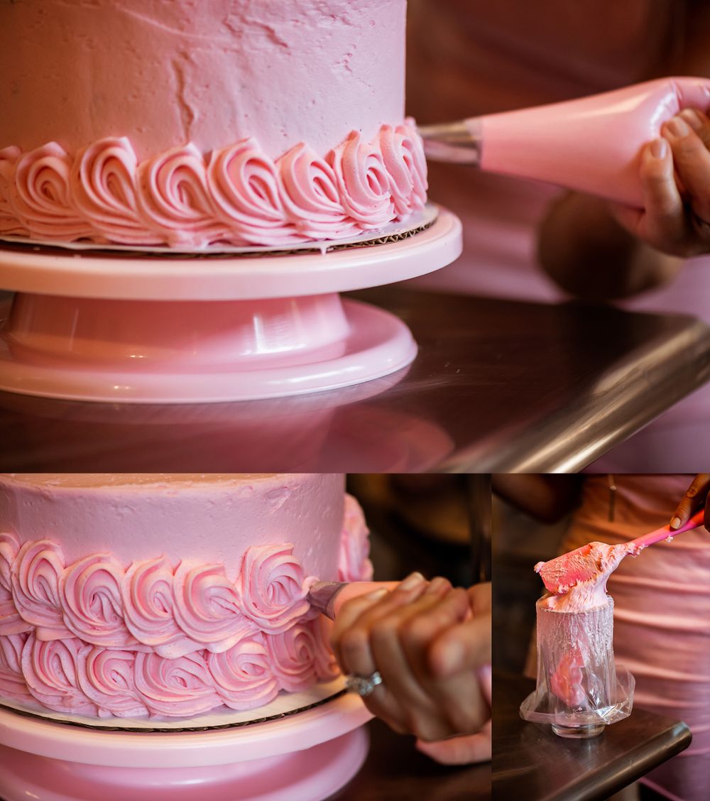 Close up of pink rosette piping details on a layered cake with decorating tools visible.