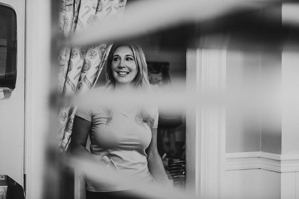 Black and white artistic shot through window panes in bakery setting.