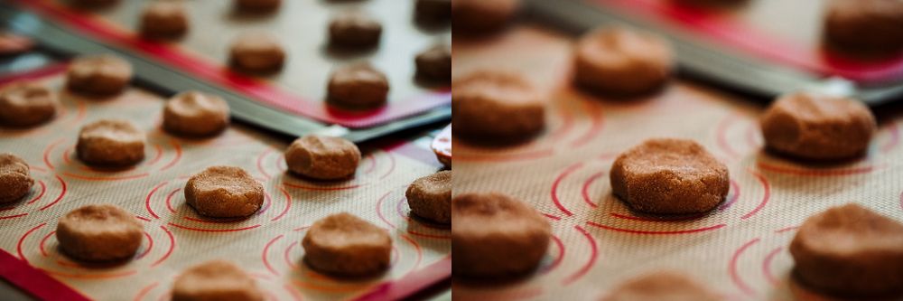 Close-up of freshly baked chocolate macarons on baking sheet.