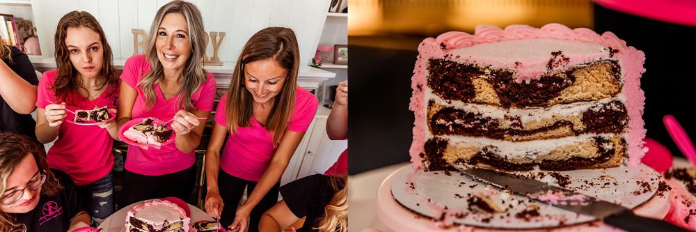 Team members sharing a layered chocolate cake with pink decorative elements.