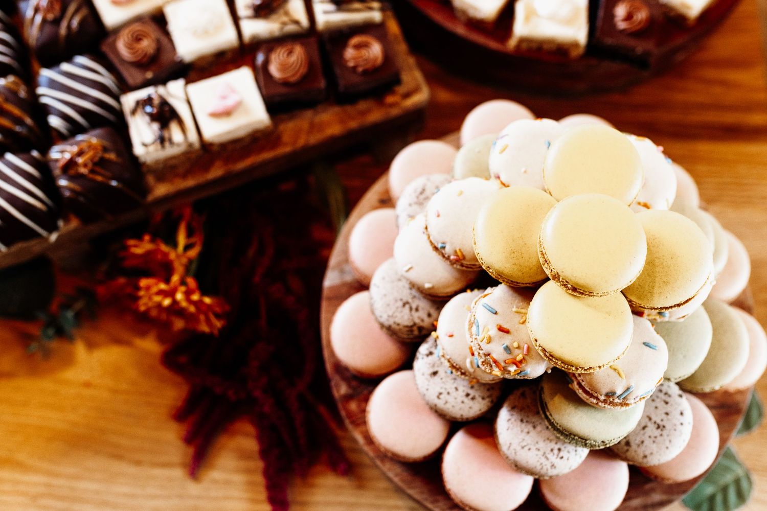 A decorative display of pink and white macarons arranged in a circular pattern.