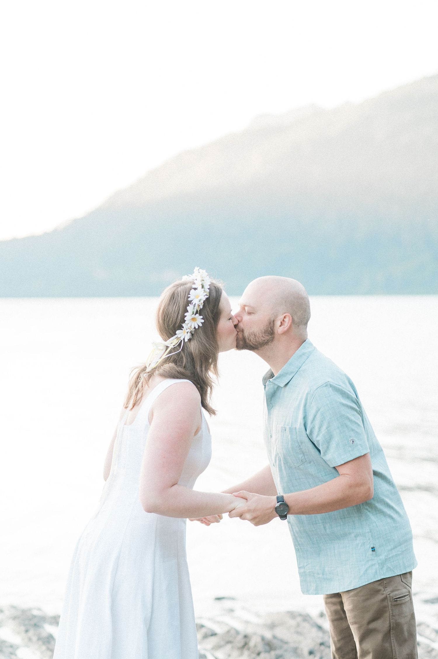 First kiss at Lake Crescent Elopement, photo by Pine + Vow.