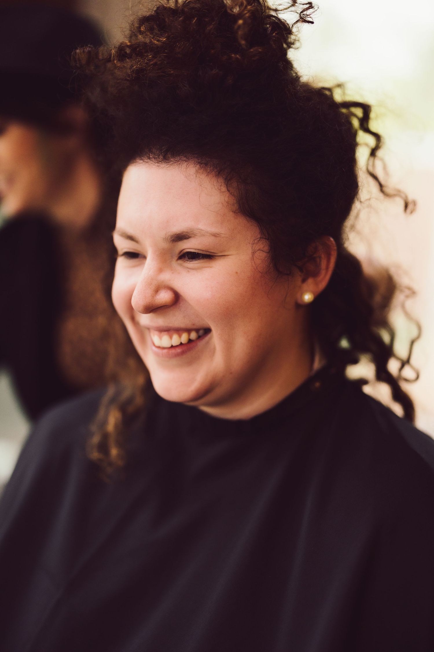 Bride laughing while hair is being done