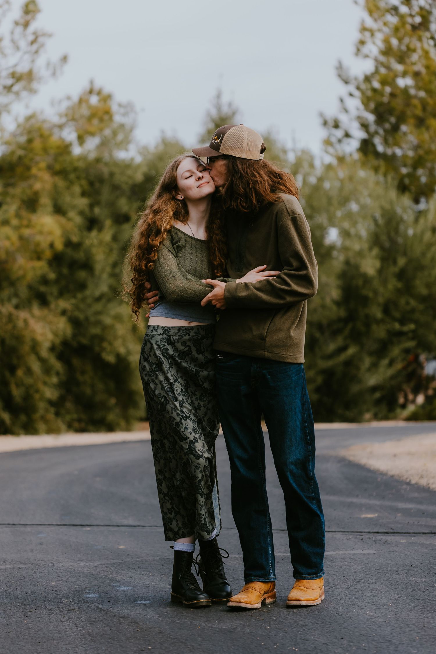 Intimate couple portrait session on a paved road at sunset.
