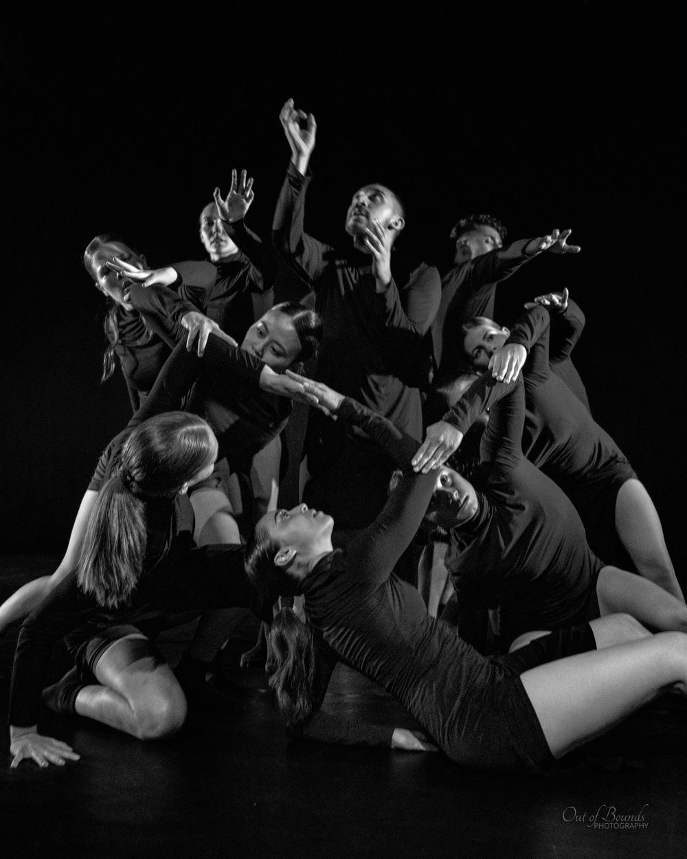 Dramatic black and white photo of dancers performing contemporary choreography.