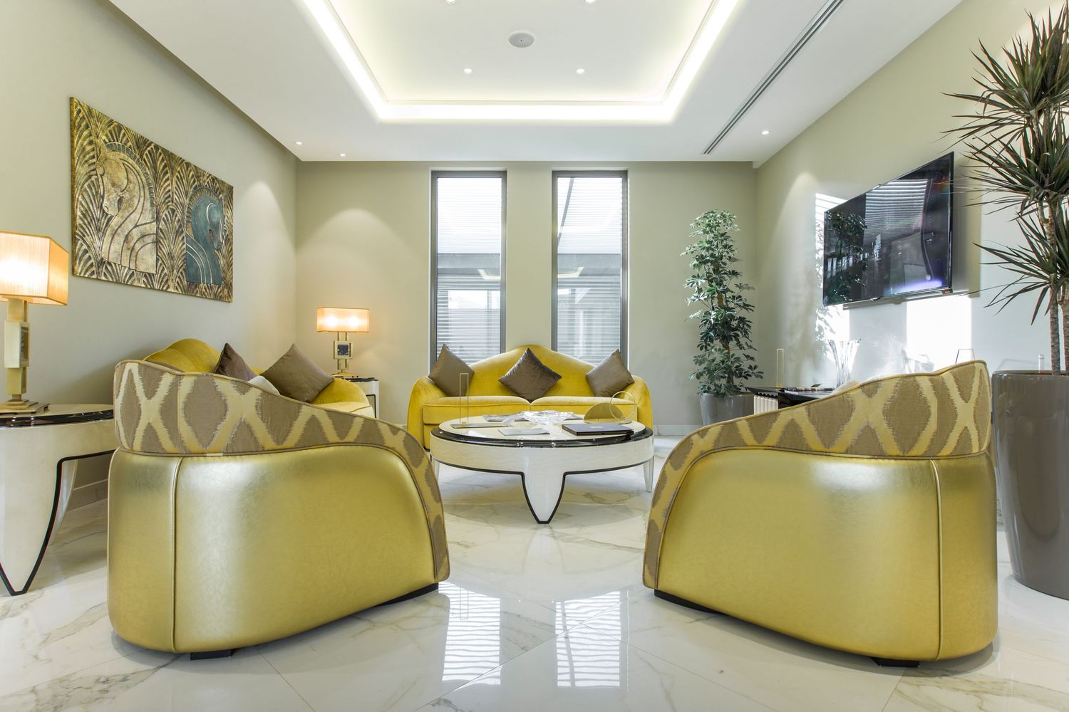 Luxury living room with yellow leather chairs and modern decor in bright setting.