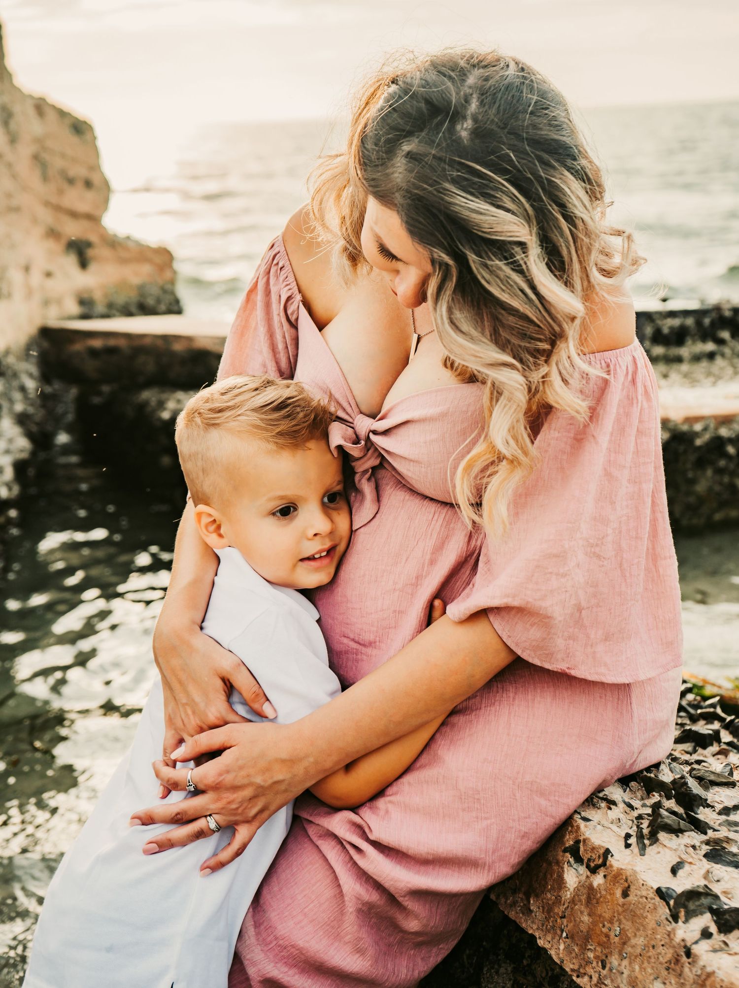 Outdoor Maternity Session at Ft. Desoto in St. Pete, FL; mother and son cuddling near ruins