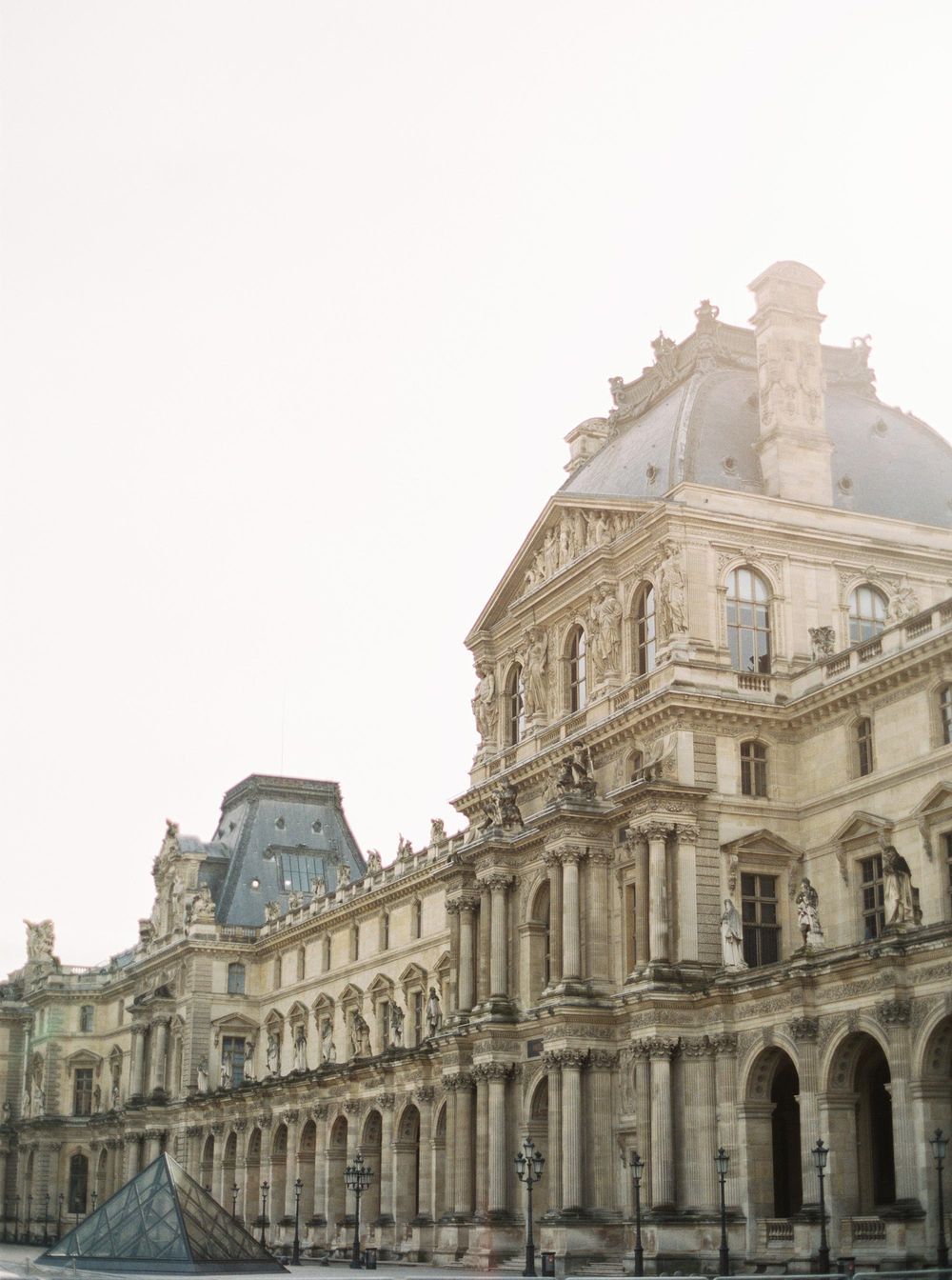 A majestic view of the Louvre Museum in Paris, showcasing its grand architecture and rich cultural heritage.