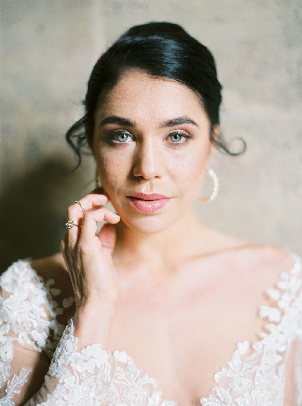Elegant bride in lace gown at Louvre, Paris.