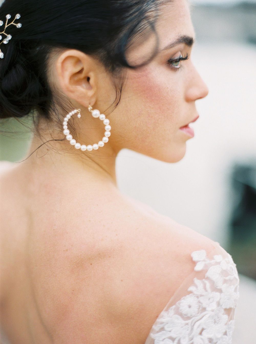 A luxury bride in a lace dress posing at Louvre, Paris.