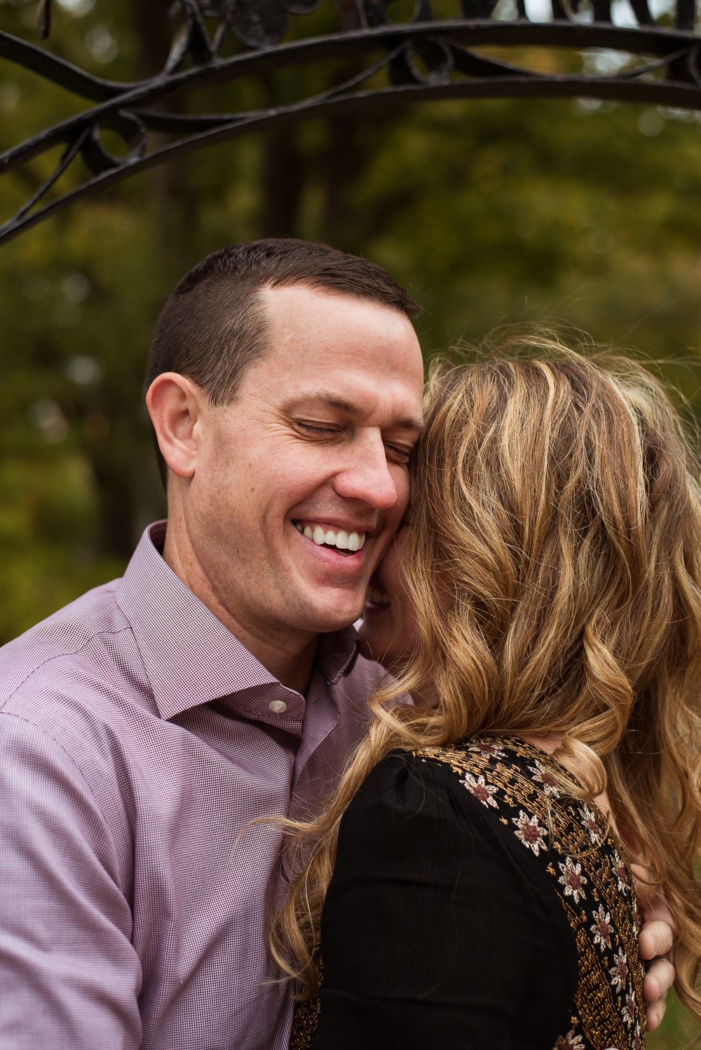 Man smiles as he hugs wife