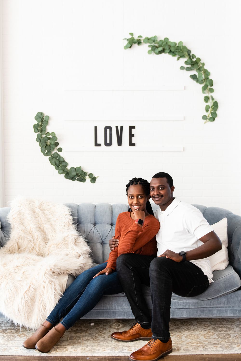Couple sits with the words love written in the background