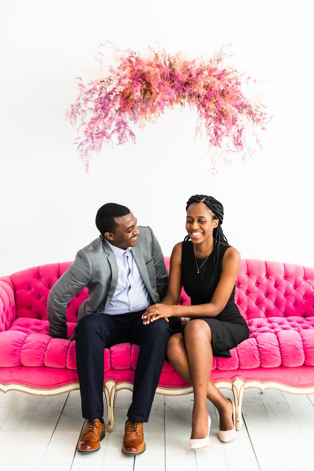 Husband looks at wife as she laughs at camera