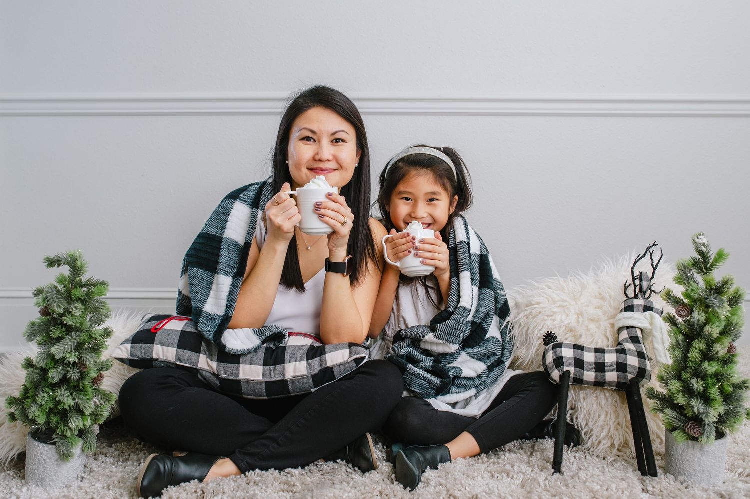 A matching buffalo plaid holiday photo with cookies and festive decorations.