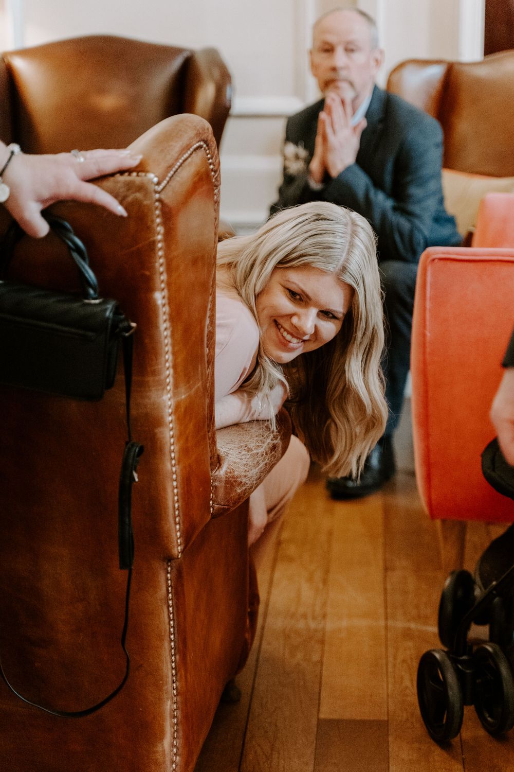 A guest looking round her chair and smiling.