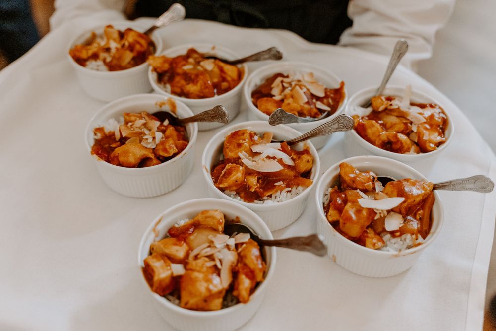 Small pots of wedding food - chicken curry and rice.