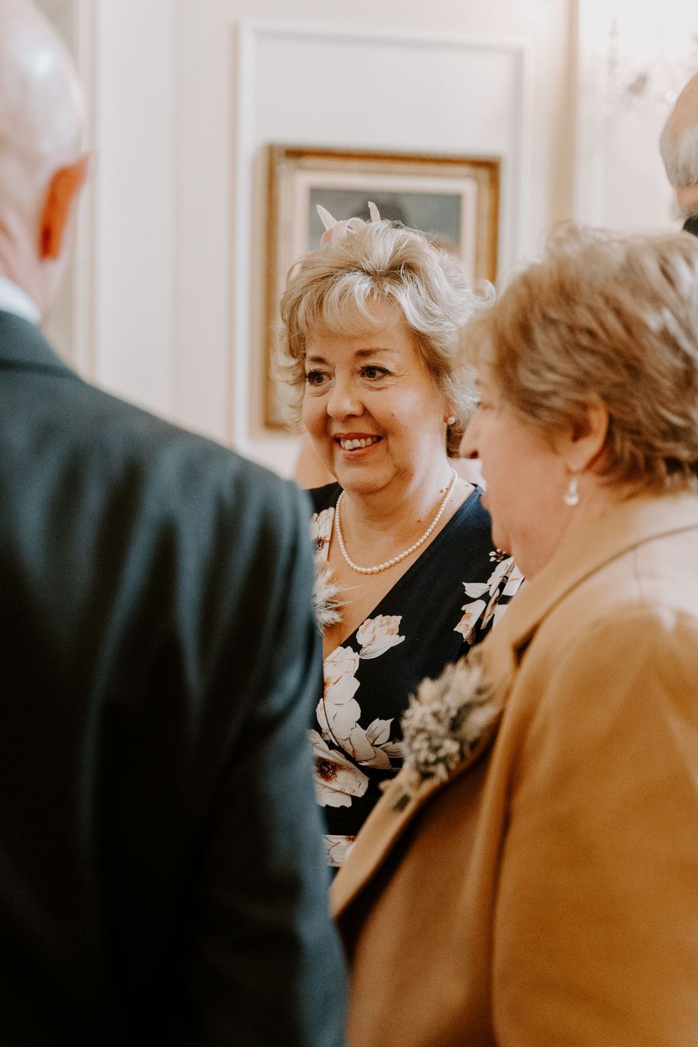 A wedding guest mingling and smiling at the reception.