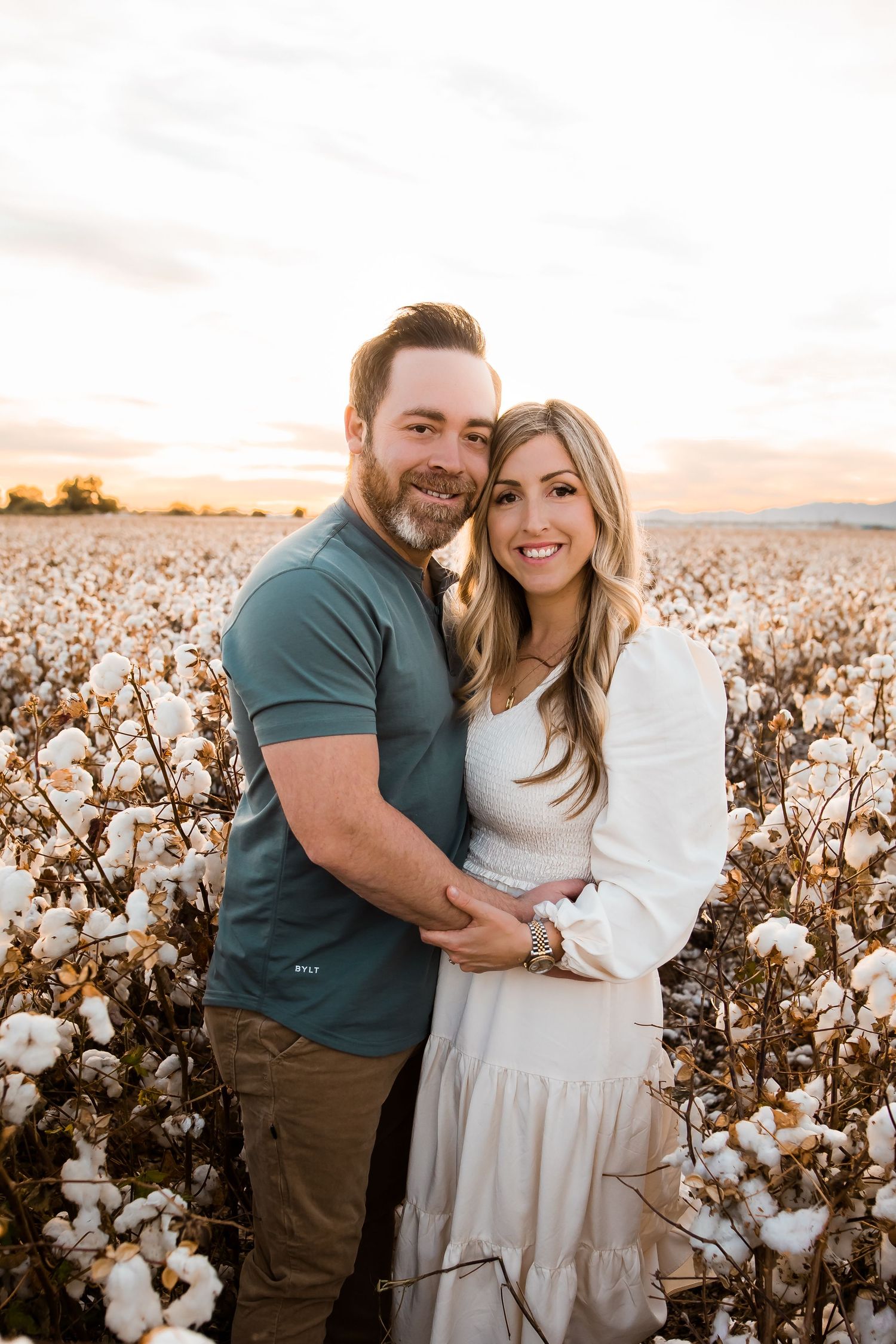 Couple loving on each other in the cotton fields of Arizona.