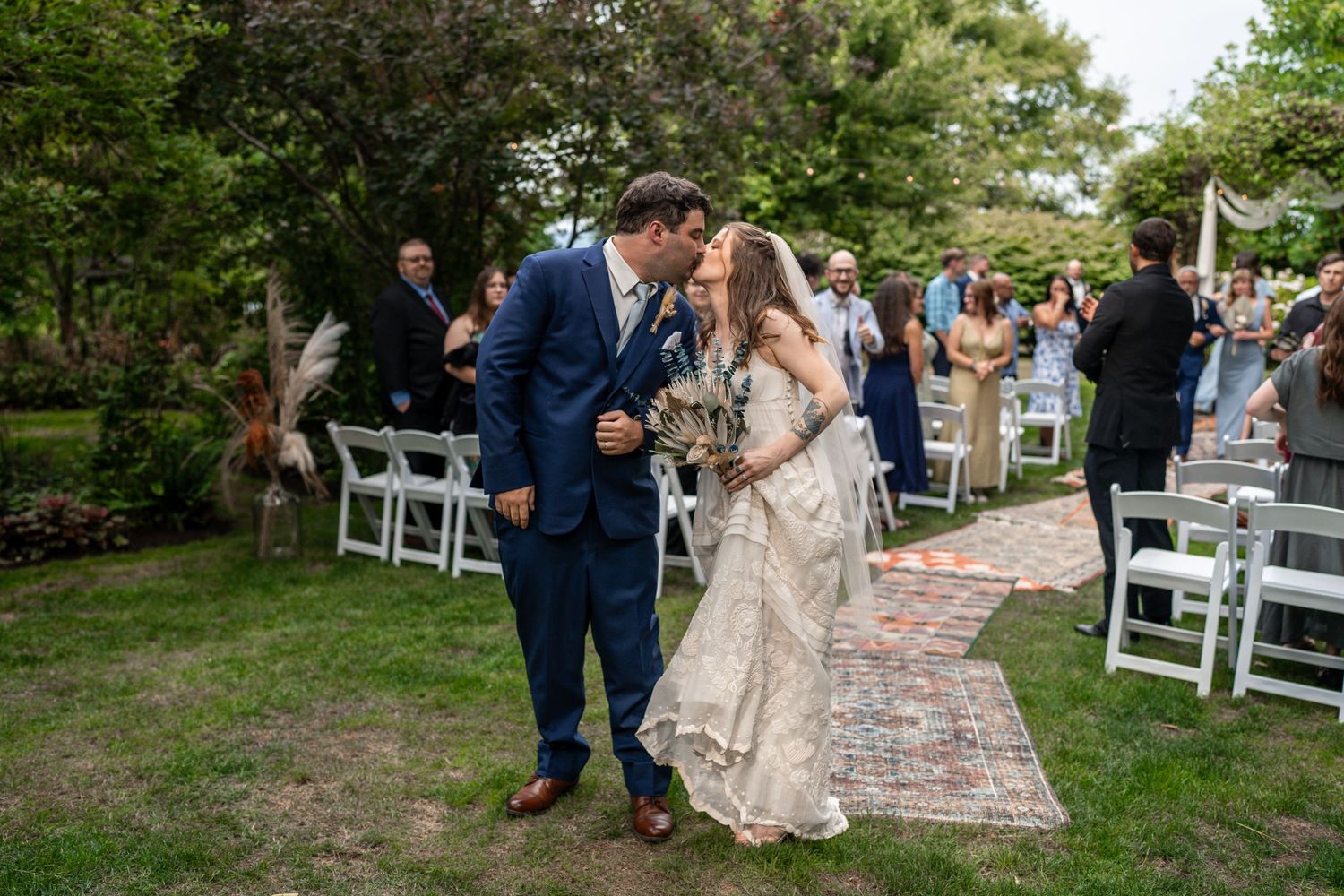 Joyful newlyweds share a moment together after their outdoor garden ceremony.