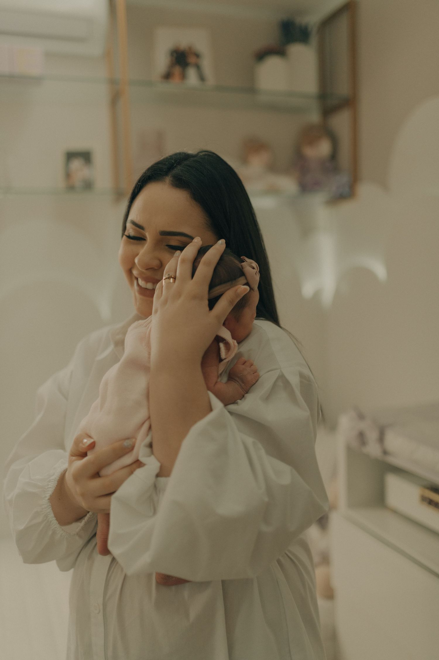 Tender moment in white showing emotional connection with a newborn baby.