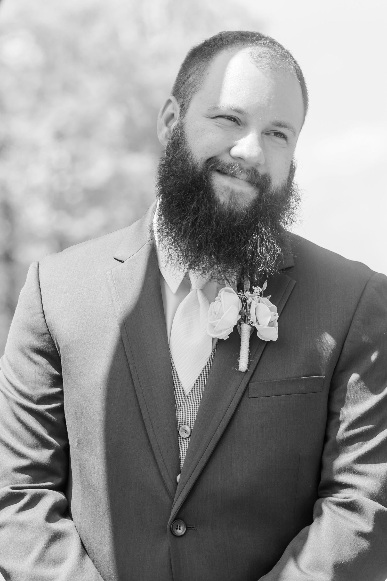 A close-up series of candid shots showing a bearded man in a dark suit smiling during a wedding.