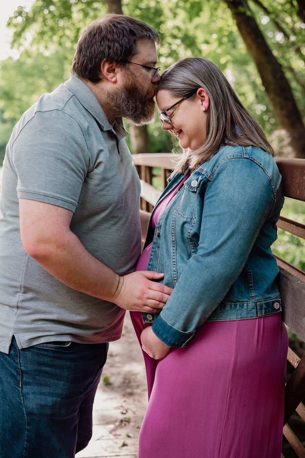 Couple in casual clothing embracing outdoors in park setting.