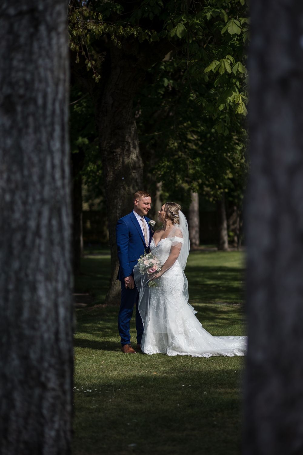Wedding couple shares an intimate moment on the front lawn at Kelham House