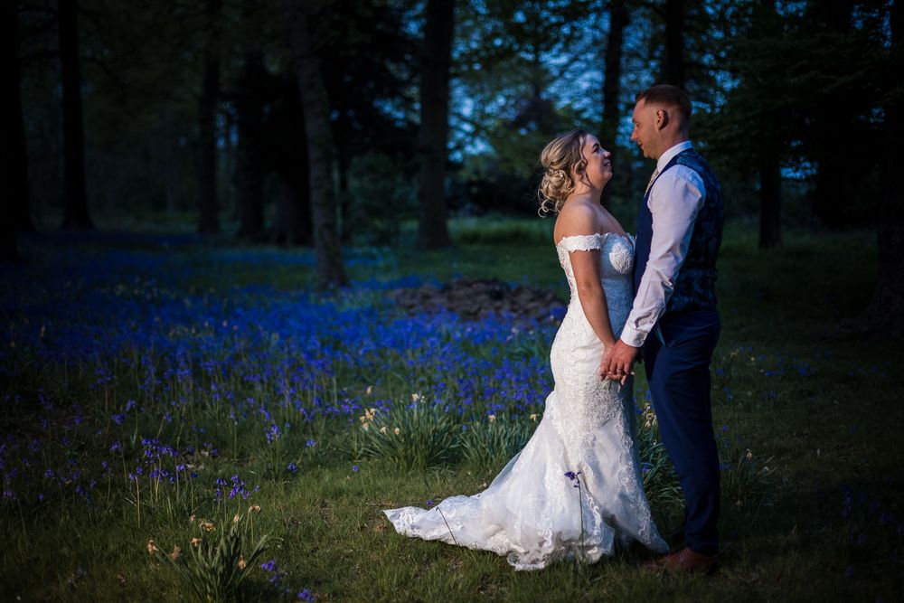 Evening wedding portraits in a field of bluebells at Kelham House