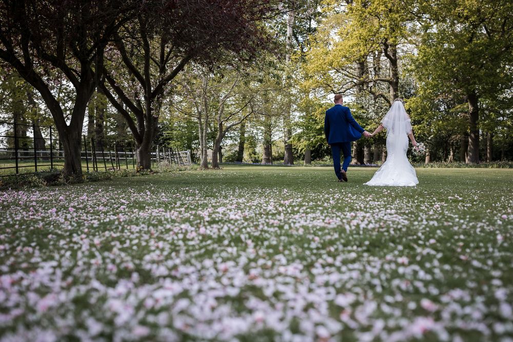 Wedding photography at Kelham House with fallen flower petals creating romantic atmosphere.
