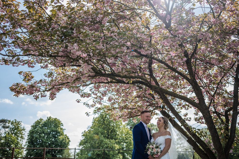Beautiful spring wedding photos with cherry blossoms and clear blue skies at Kelham House