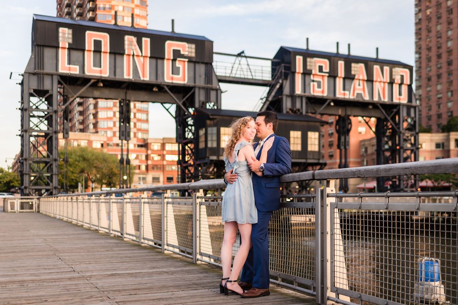 Couple shares romantic moment under iconic Long Island sign in New York.