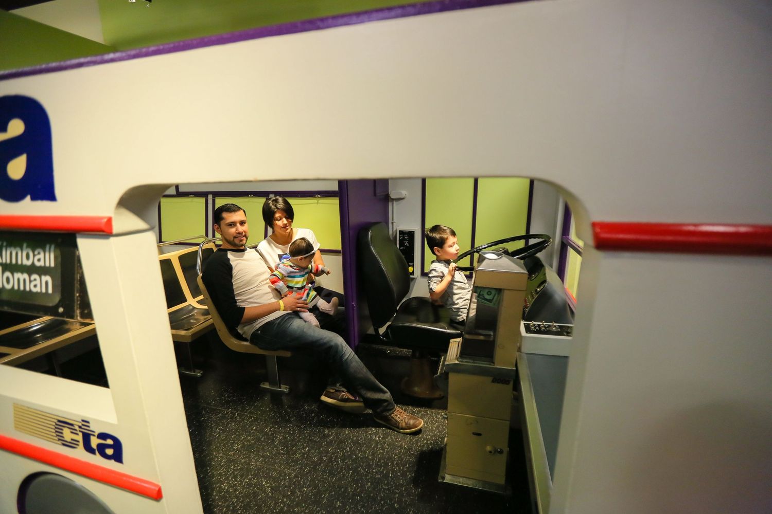 Interior view of an office space with modern furniture and purple wall accents.