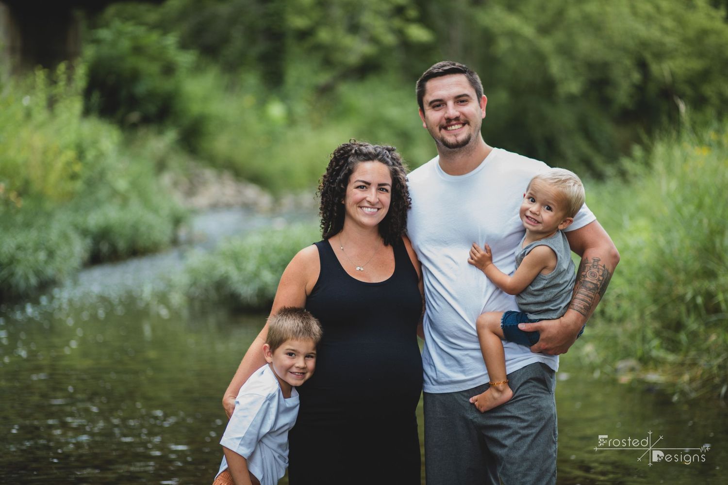 Family of 4 soon to be 5 in creek at Arbuckle Acres Park for Maternity sesion.