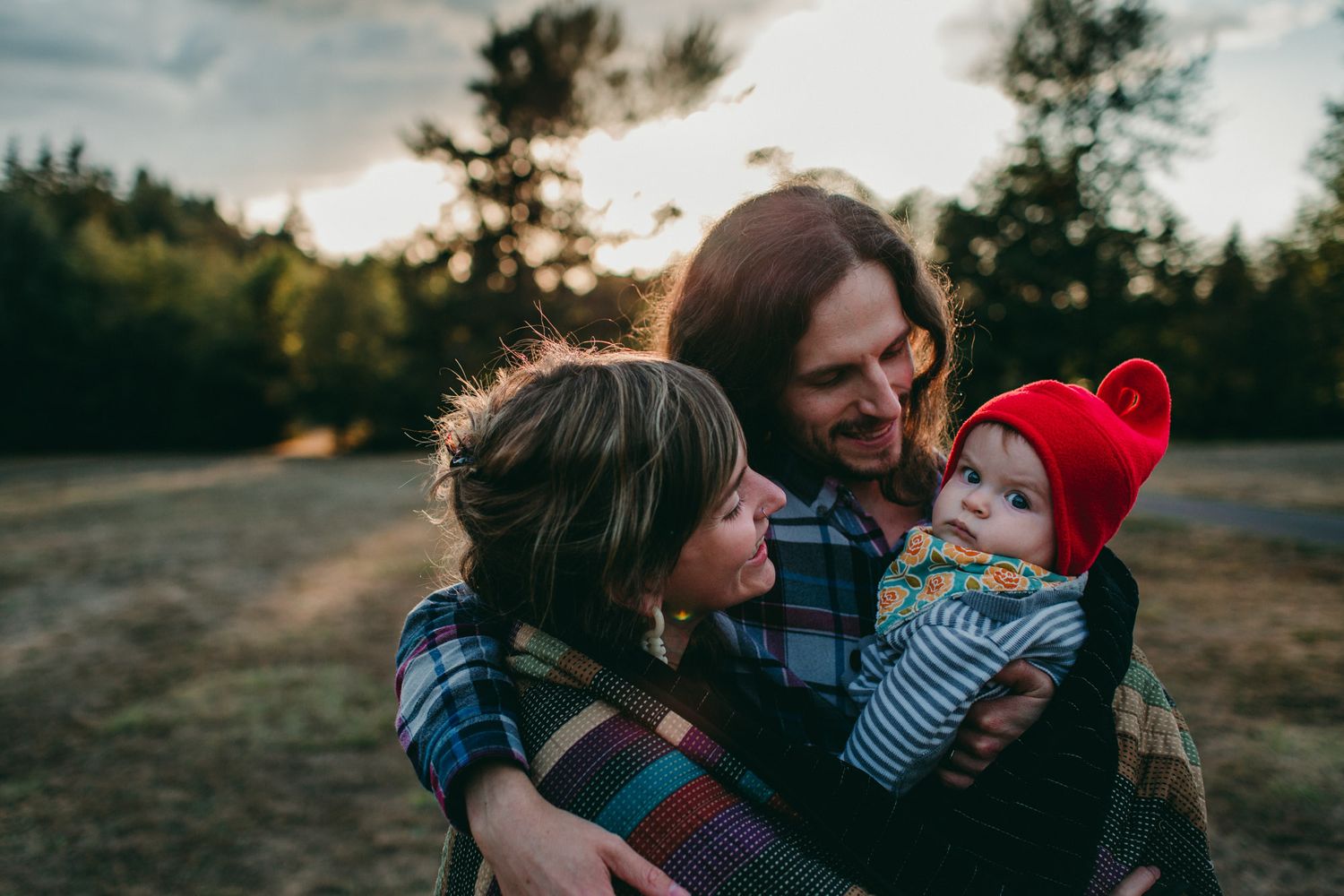 queer trans parents hold baby at sunset family session portland oregon photographer