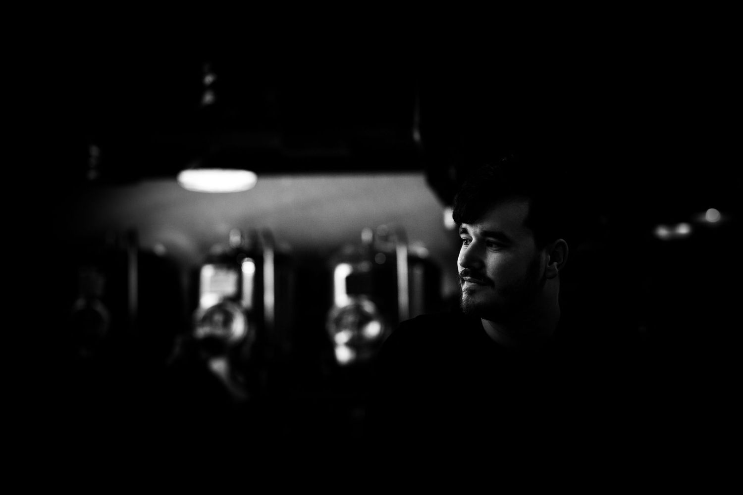 A silhouetted profile captured in dramatic black and white lighting at night.