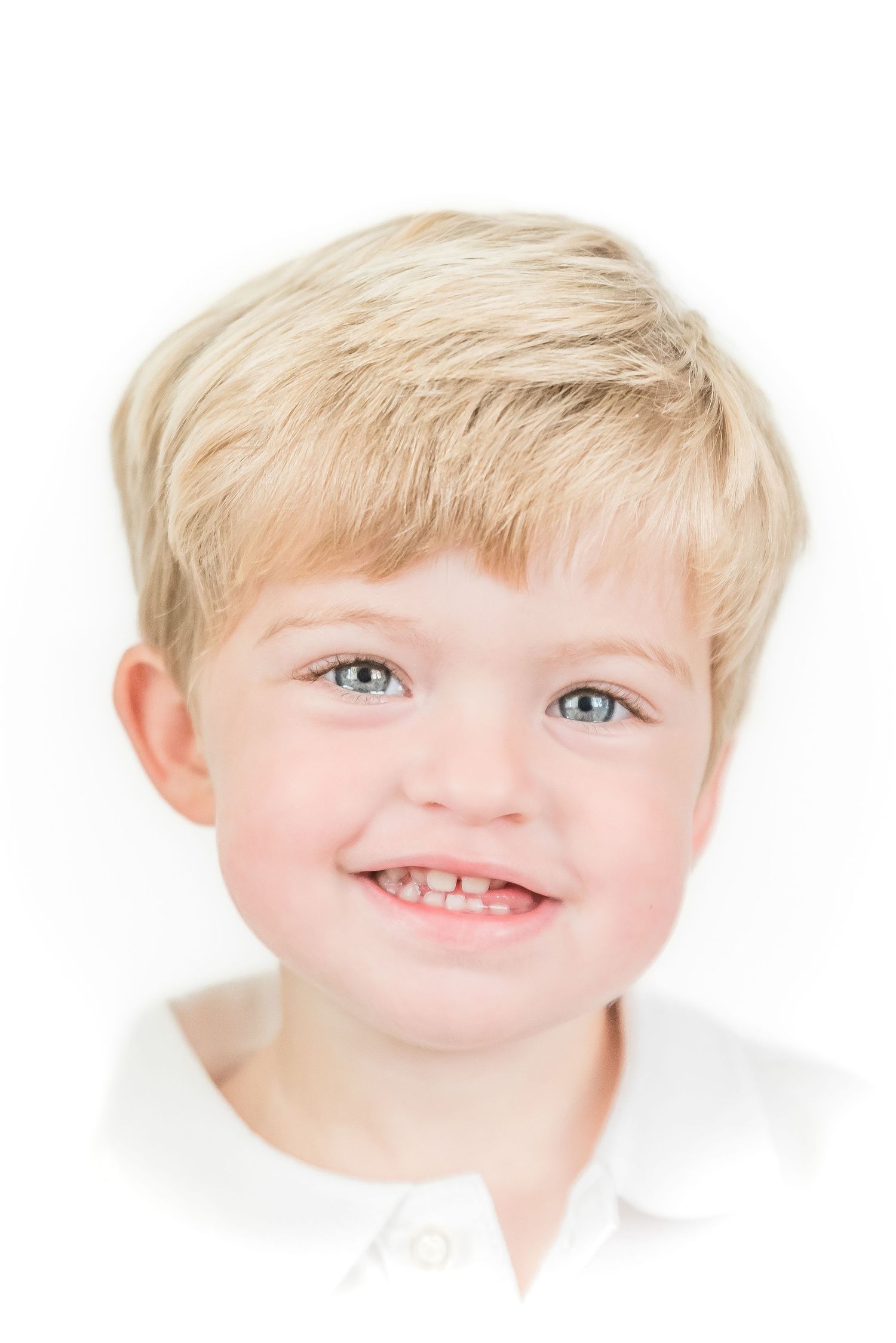 Boy smiling, white backdrop