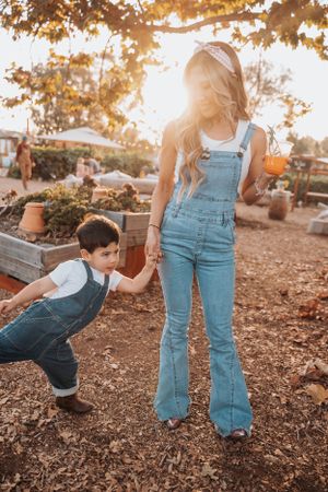 A sunny afternoon scene in overalls exploring a garden path together.