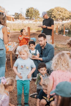 A casual outdoor gathering of family and friends enjoying time together on a sunny afternoon.