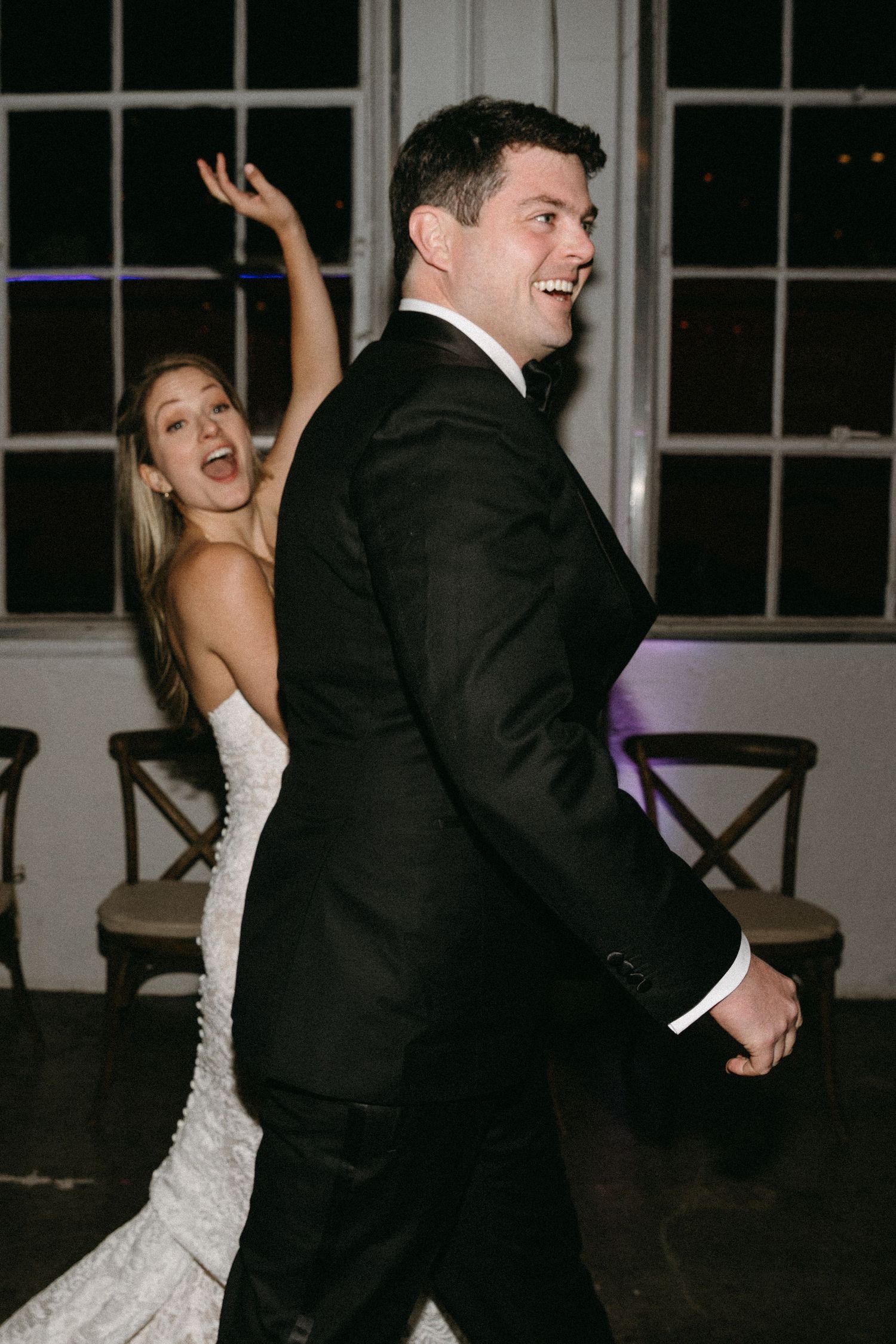 Dancing newlyweds sharing a joyful moment on their wedding day.