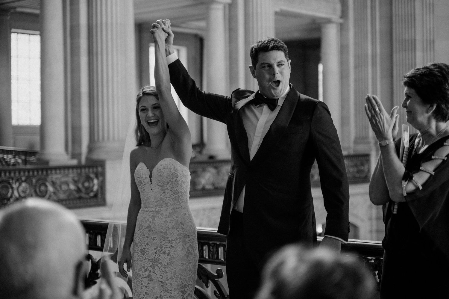 A joyful celebration moment during a wedding ceremony in a classical venue.