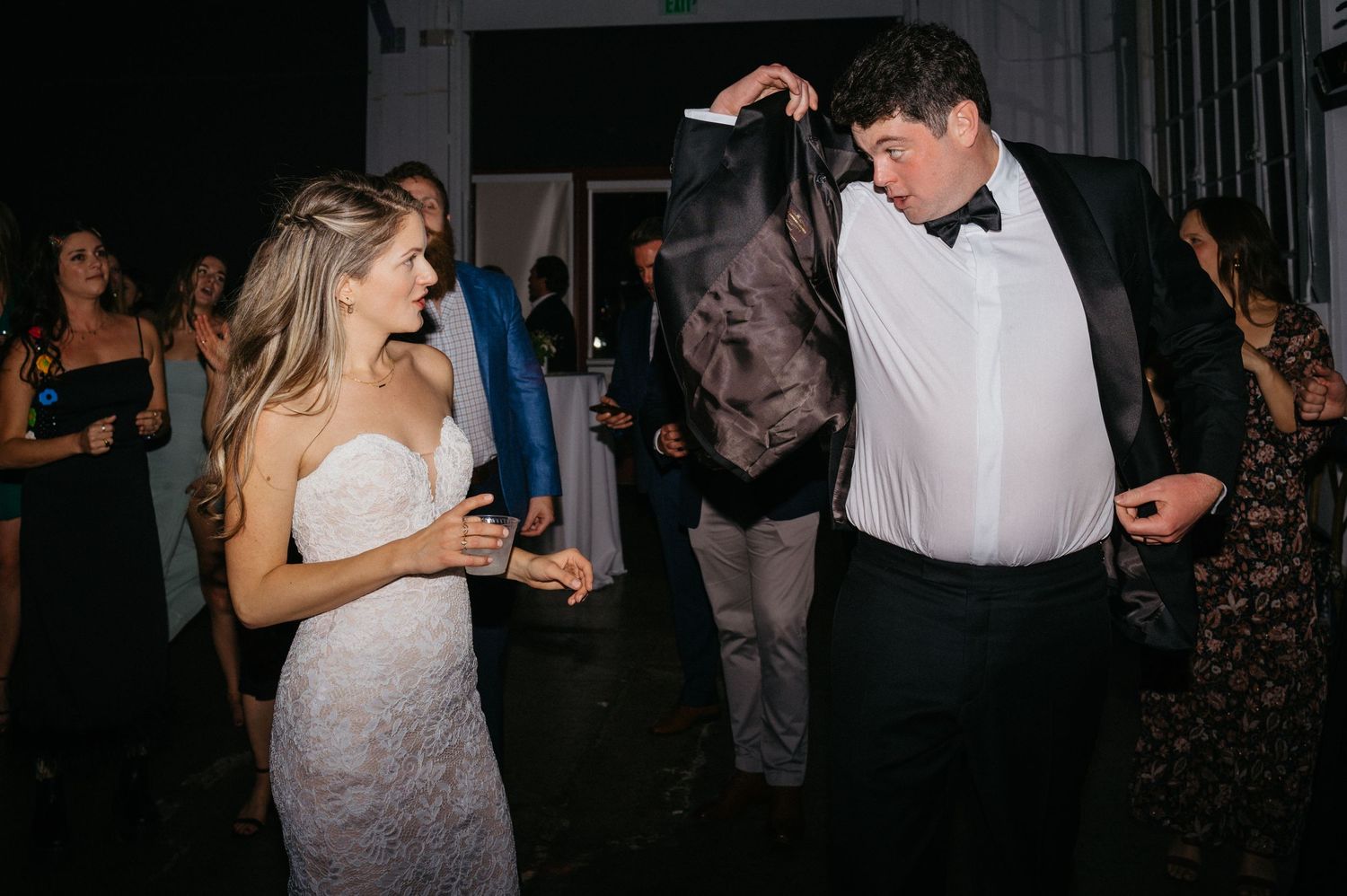 Wedding couple sharing a playful dancing moment at their reception.