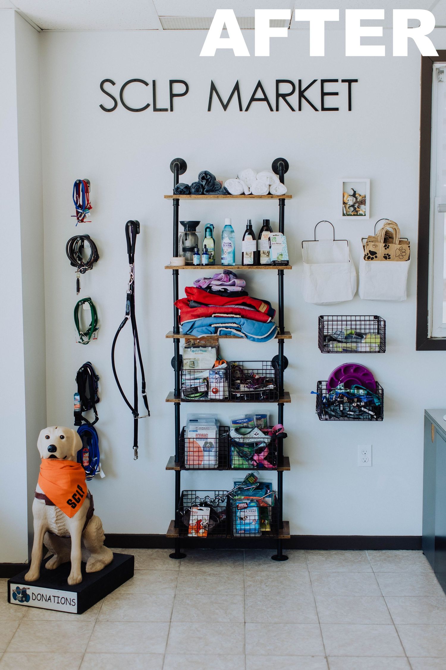 Organized retail space with shelving units displaying merchandise and a dog statue in the corner.