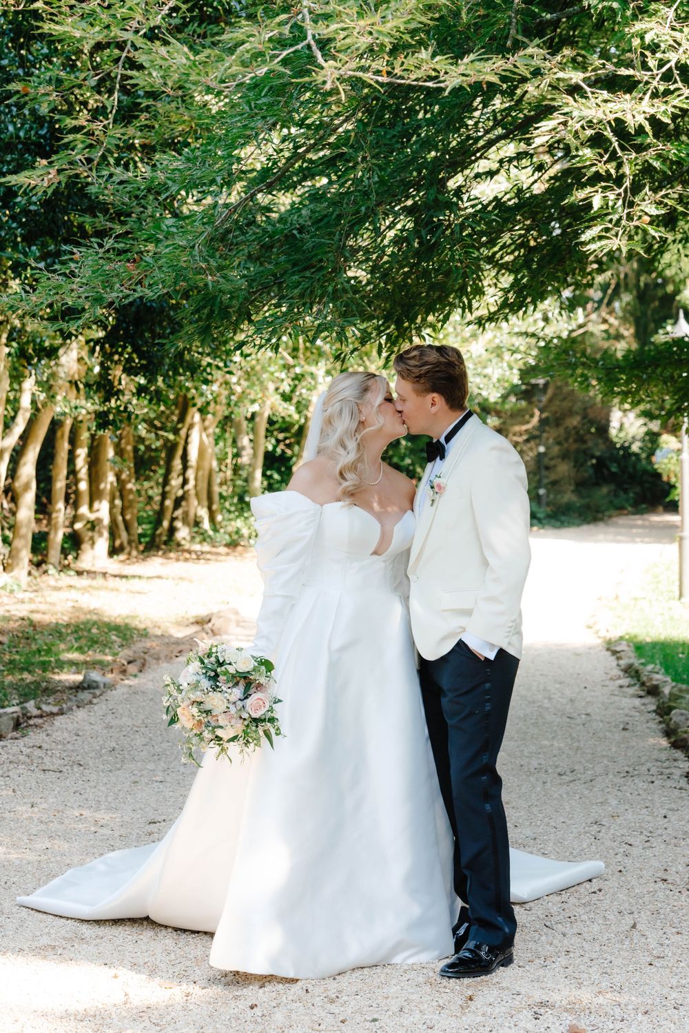 Zara Davis Cotswolds Wedding Photography Cheltenham Gloucestershire Old Down Estate Luxury London Bristol Bath couple walking down path kiss