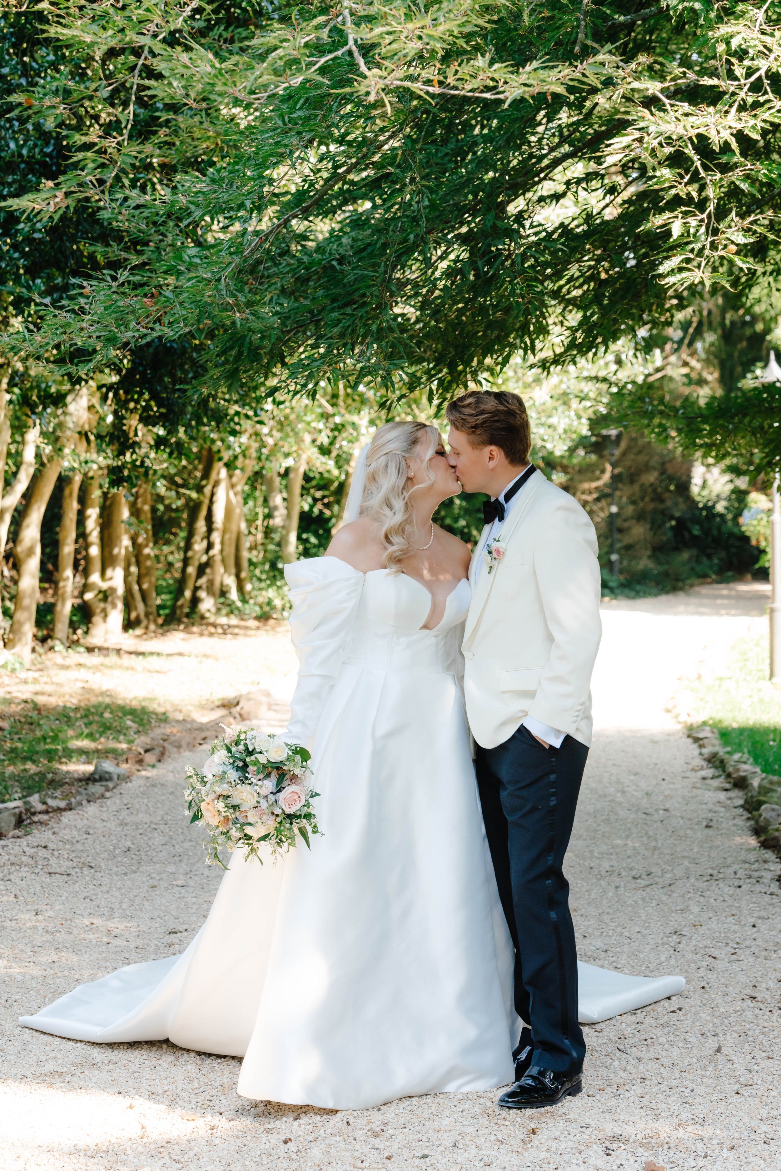 Zara Davis Cotswolds Wedding Photography Cheltenham Gloucestershire Old Down Estate Luxury London Bristol Bath couple walking down path kiss