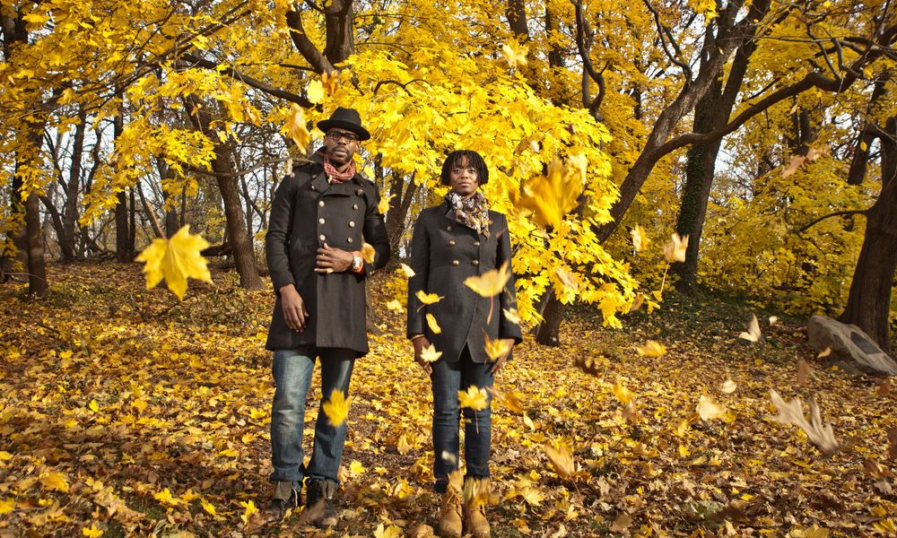 Musicians in a golden leaf-filled park, surrounded by the vibrant colors of autumn.