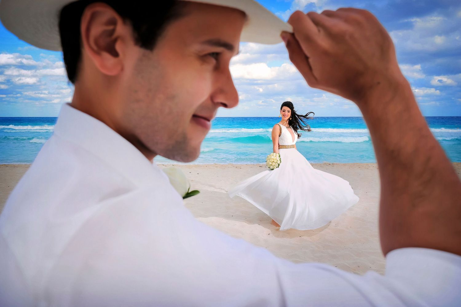 A beach wedding scene with flowing white dress against turquoise ocean waters.