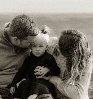 A series of intimate black and white family photos showing tender moments between parents and child.