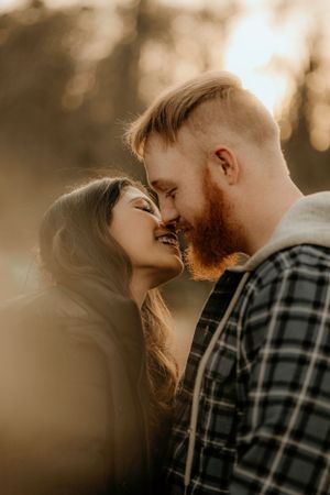 Intimate close-up portrait of a couple in warm sunset lighting.