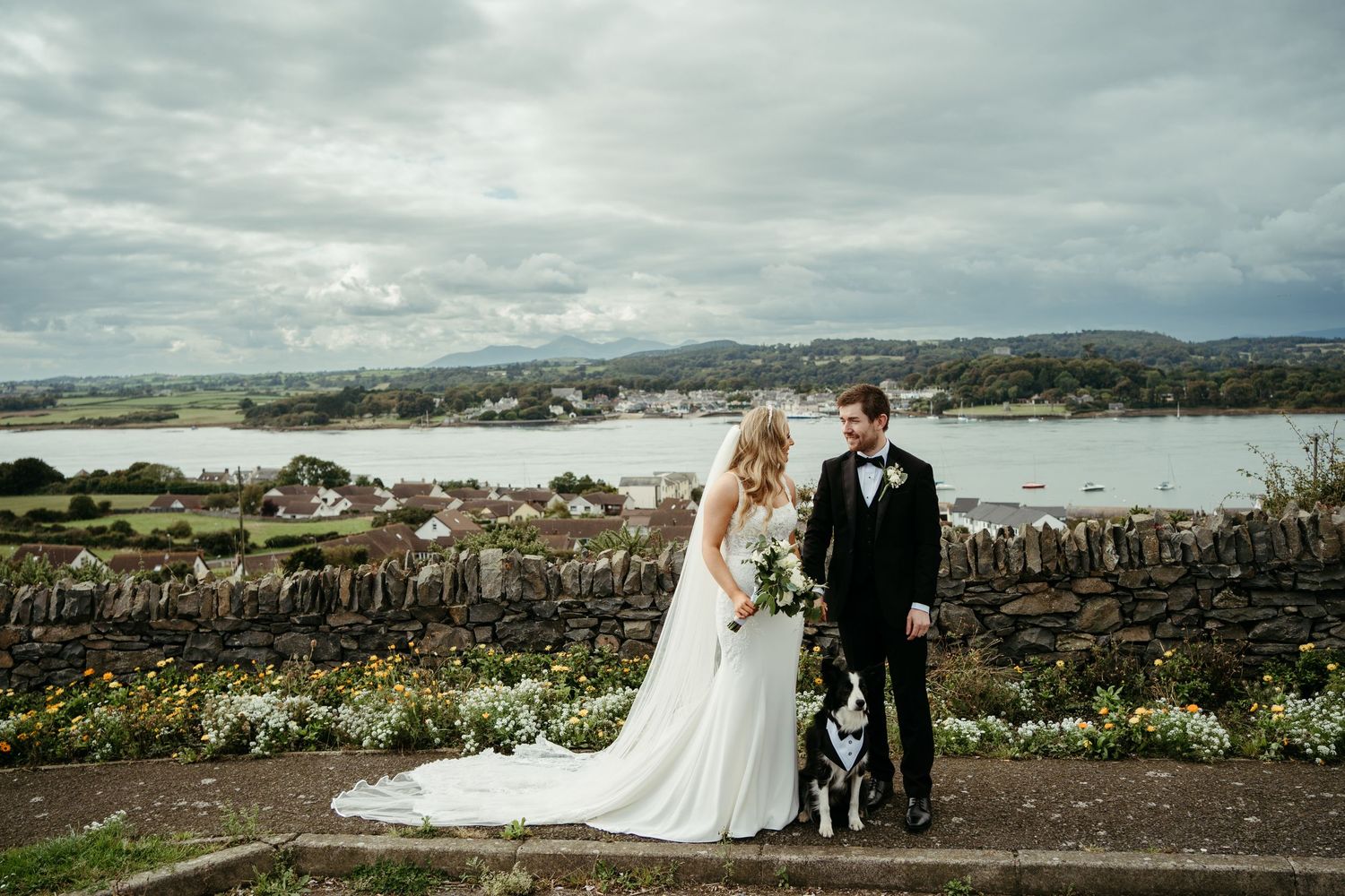 Scenic wedding photography session on rocky coastal landscape.
